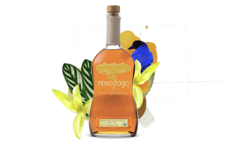 Novo Fogo Barrel Aged Cachaça with bird and flowers behind